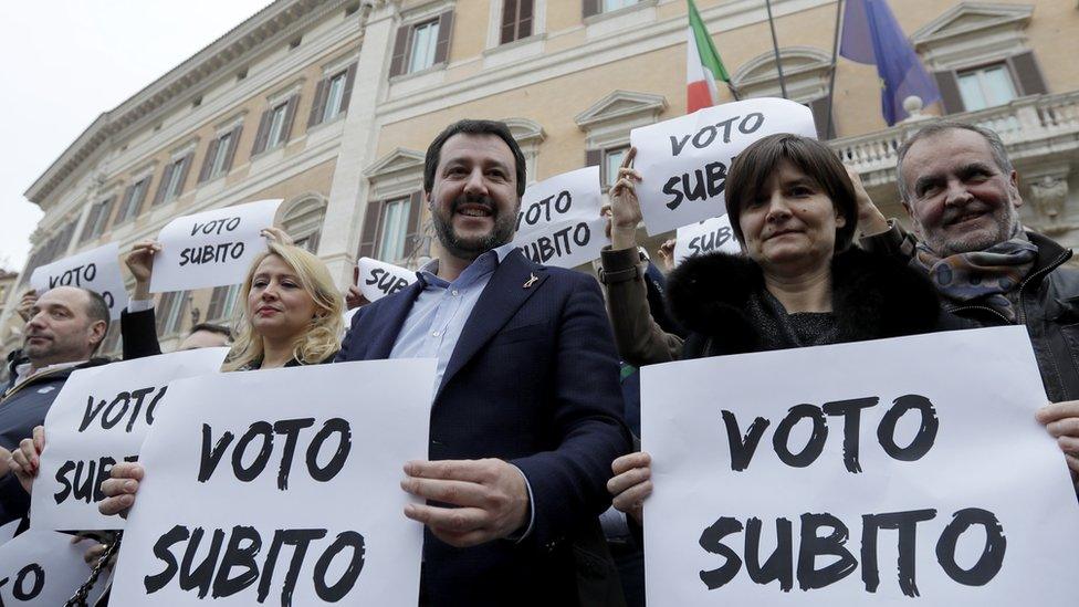 Northern League leader Matteo Salvini (C), holds a placard that reads "Vote Now"