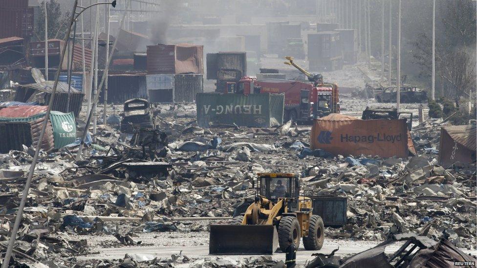 A bulldozer works near the site of the explosions at the Binhai new district, Tianjin, August 13, 2015.