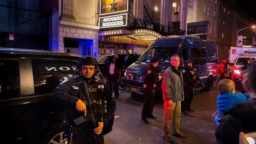 Heavily armed police stand guard as a motorcade carrying Vice President-elect Mike Pence,