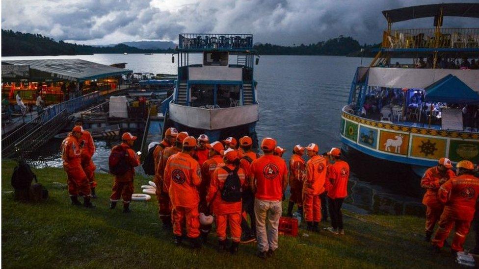 Rescue officials gather to take part in a search for survivors