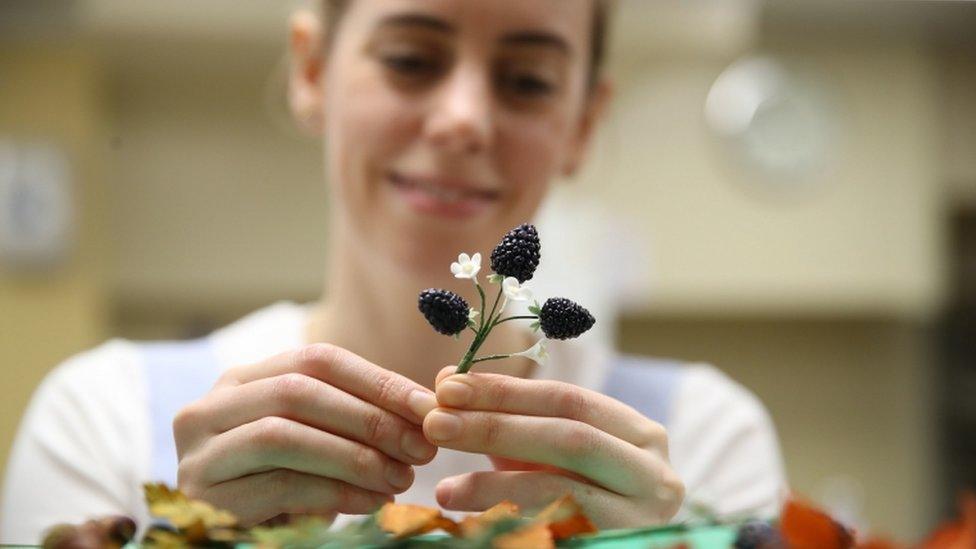 Baker Sophie Cabot with decorations to be used on Princess Eugenie's red velvet and chocolate wedding cake