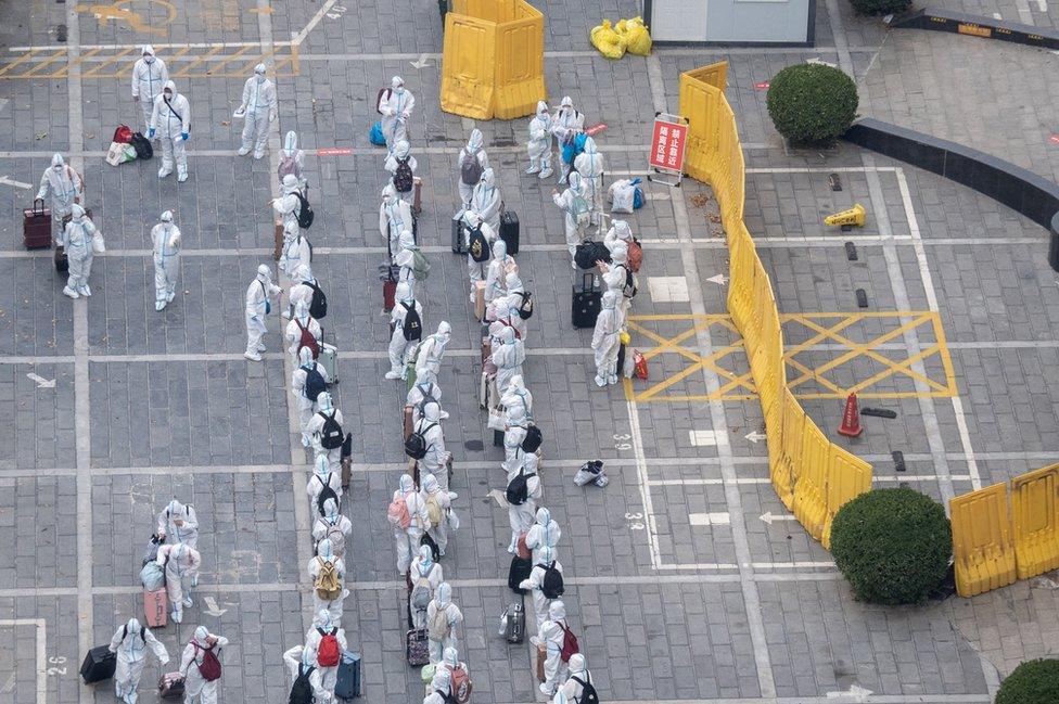 Residents wearing personal protective equipment (PPE) line up to enter a specialized hotel for medical observation and quarantine as Zhengzhou eases COVID-19 restrictions on November 1, 2022 in Zhengzhou, Henan Province of China.