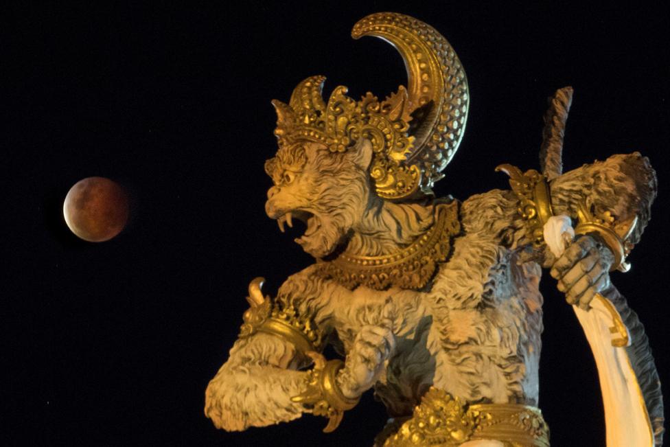 The full moon, known as "Super Blood Moon", rises over the Titi Banda park in Denpasar, Bali, Indonesia, May 26, 2021