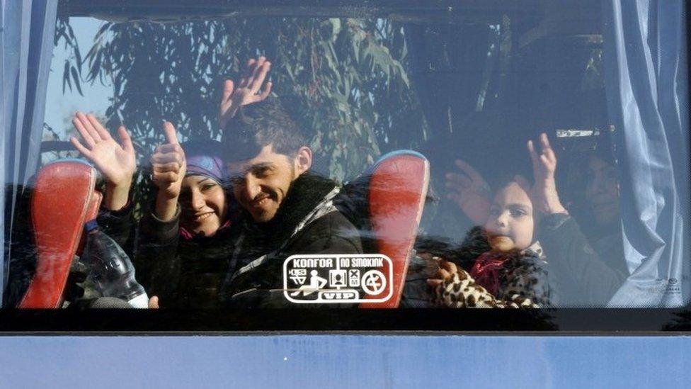 A bus transports people from a rebel-held suburb in Homs