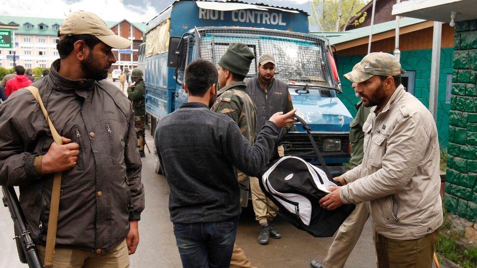 An Indian policeman checks the bag of a student near the main gate of National Institute of Technology (NIT) in Srinagar, summer capital of Indian administered Kashmir, 06 April 2016