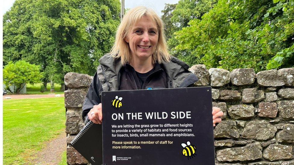 Sarah Franklin with new signs which are being erected around Dryburgh Abbey