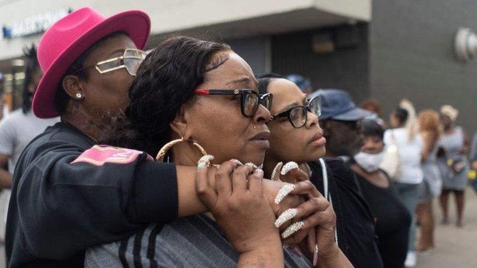 Onlookers at the crime scene of a shooting at Tops Friendly Market store in Buffalo, New York on 14 May