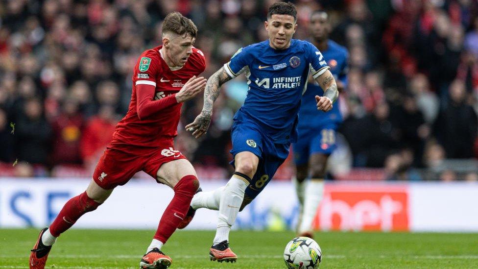 Liverpool's Conor Bradley (left) breaks away from Chelsea's Enzo Fernandez