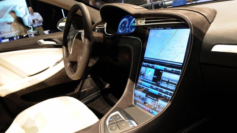 Interior of Tesla car showing large computer screen