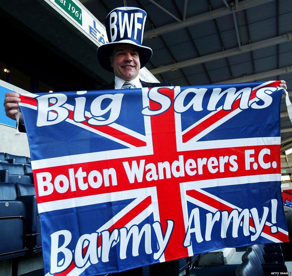 Sam celebrating with a Bolton flag