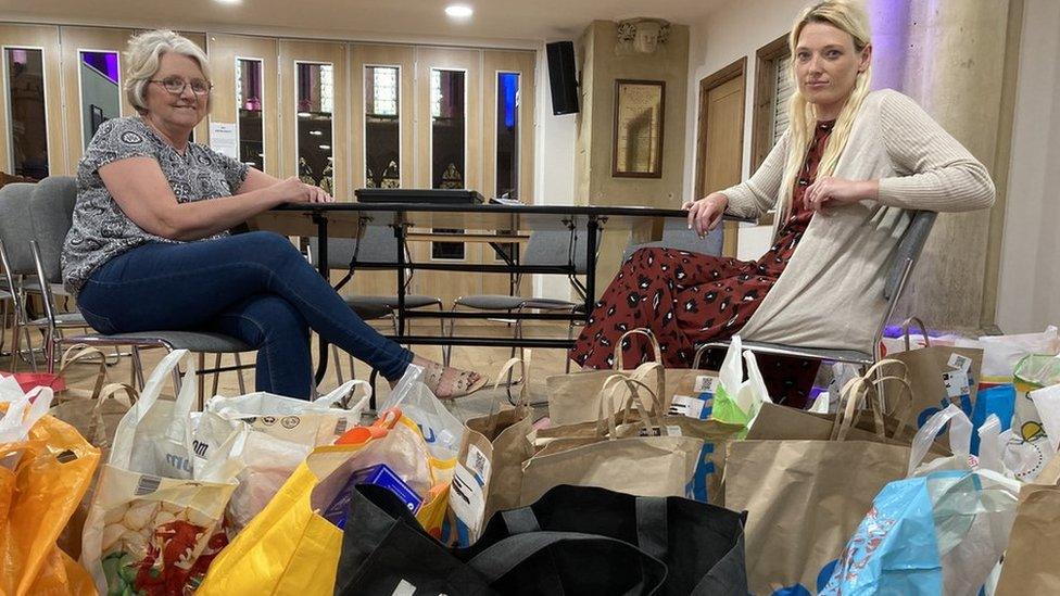 Volunteers pictured with food donations