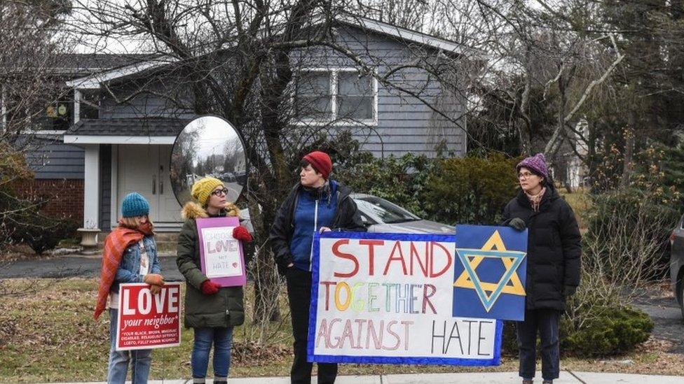 People show support to the Jewish community with banners