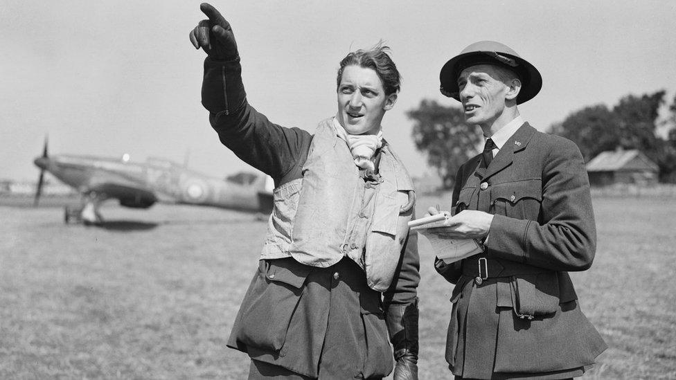 Pilot speaks to intelligence officer at RAF base during Battle of Britain