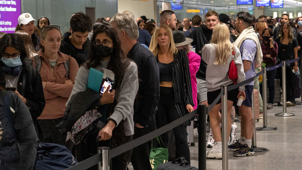 People queue at Heathrow airport