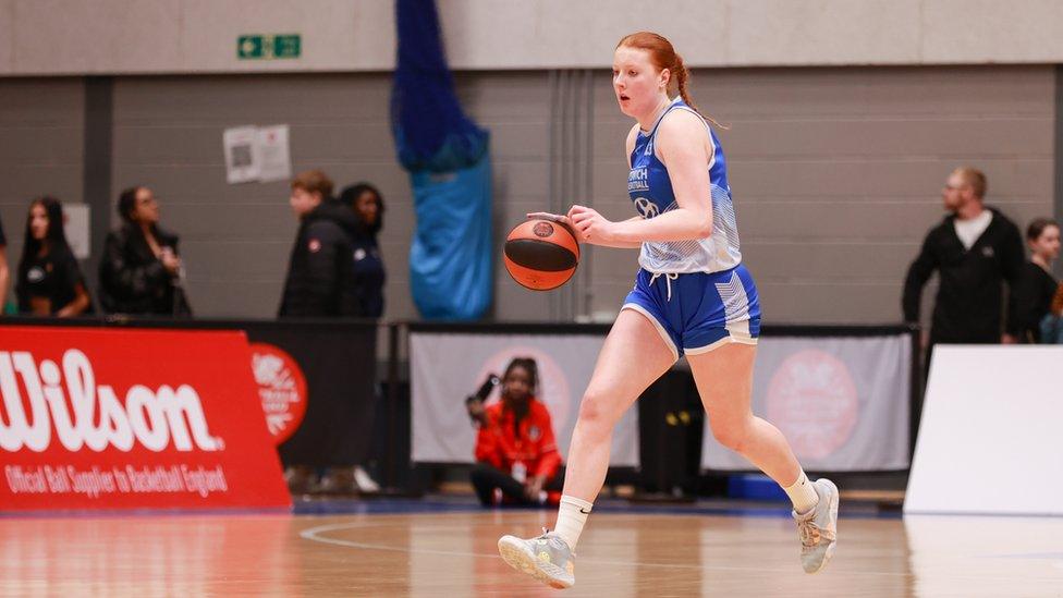 Gibbins on the ball, in her Ipswich Basketball blue jersey