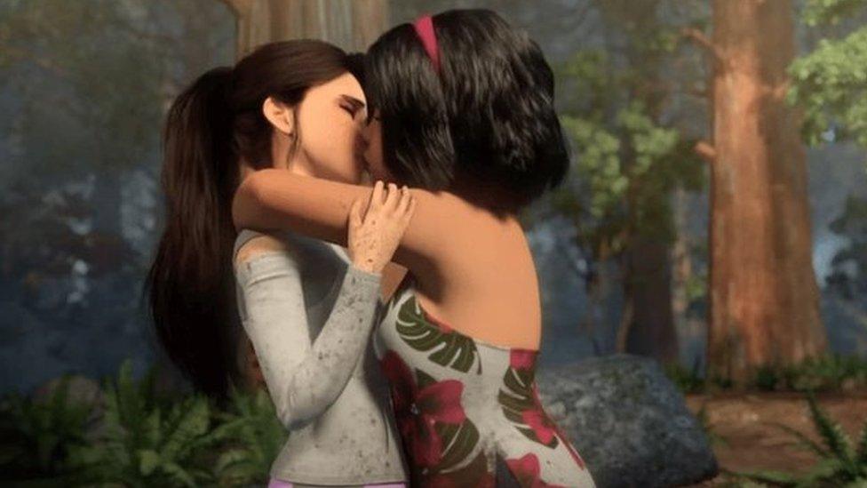 Screengrab from the animated Netflix show Jurassic World: Camp Cretaceous showing two teenage girls kissing each others