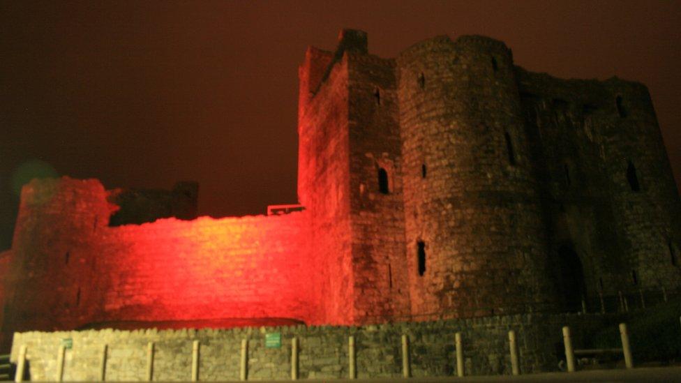 Kidwelly Castle lit up red