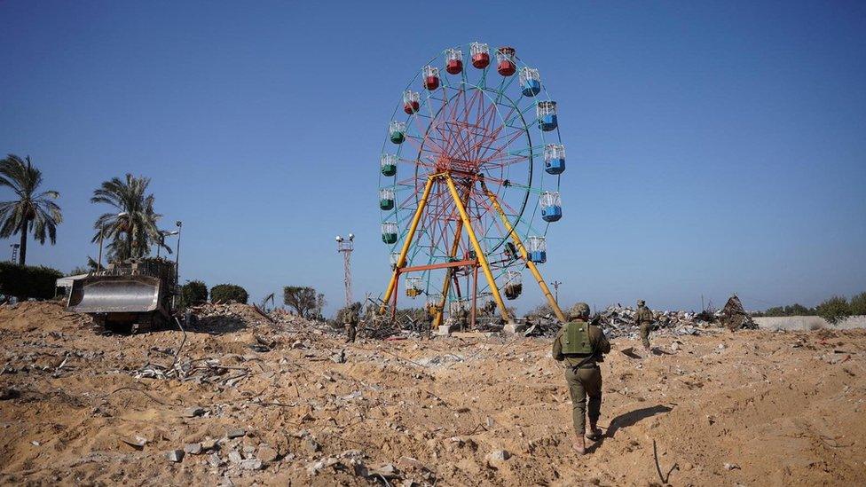 Israel Defense Forces (IDF) handout showing Israeli soldiers walking towards a fair ground inside the Gaza Strip (8 November 2023)