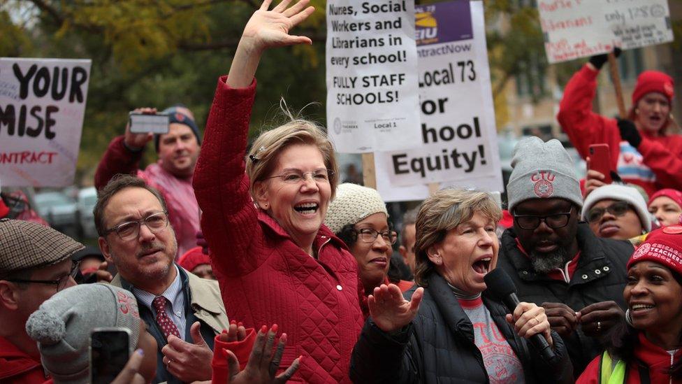 Elizabeth Warren in a crowd of teachers holding protest signs