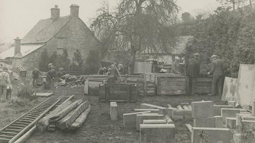 Men packing stones into sacks