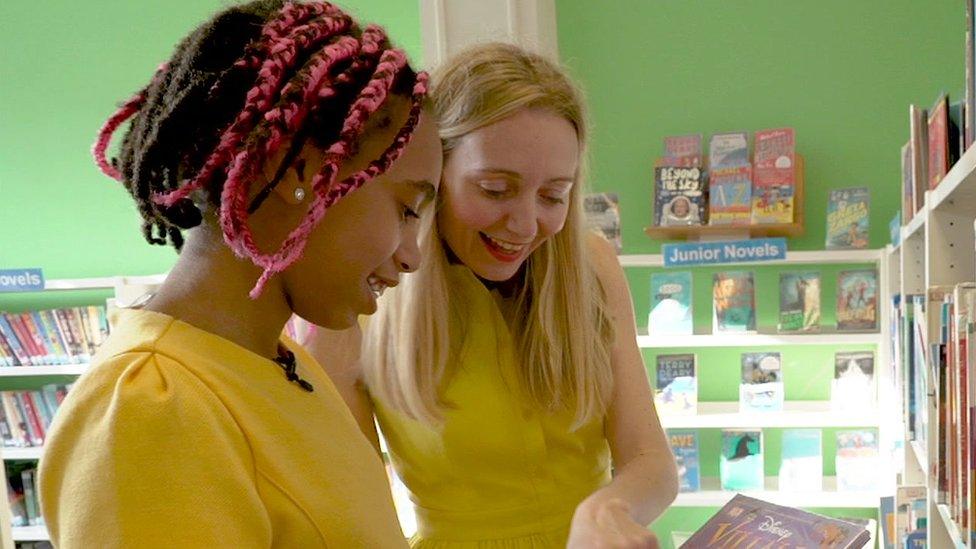 Cerrie and her daughter looking at books.