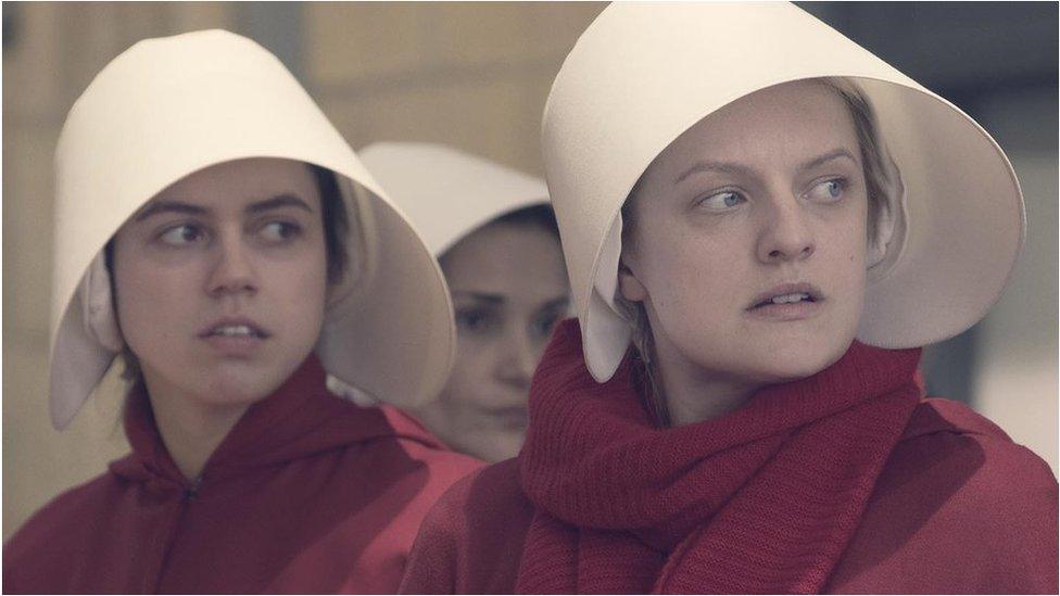 Nina Kiri and Elisabeth Moss in The Handmaid's Tale