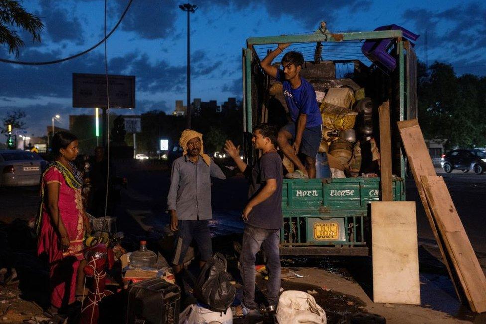 harmender Kumar, who works as a clerk at Pragati Maidan which houses the main venue of the G20 Summit, and his wife Khushboo Devi load their belongings in a vehicle after their house was demolished during a demolition drive by the authorities at a slum area near the upcoming summit venue in New Delhi, India, June 1, 2023. REUTERS/Adnan Abidi