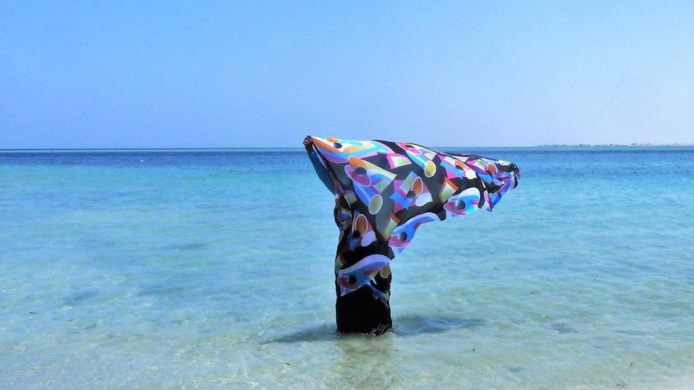 Woman stands in the water at the Sudanese Red Sea coast