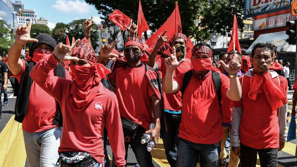 A group of "Red Shirts" gather for a counter protest in Kuala Lumpur