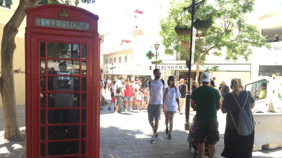 Red telephone kiosk on a street in Gibraltar