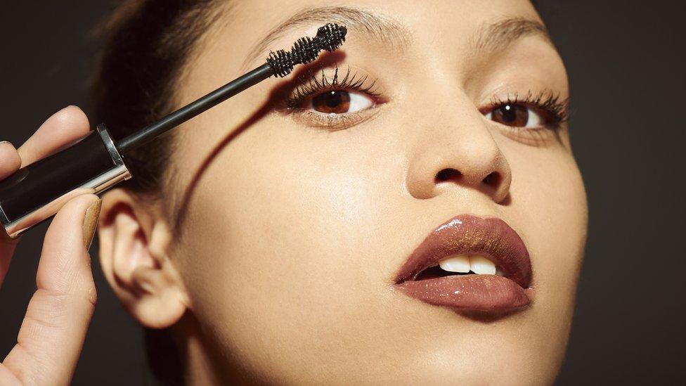 Stock shot of woman applying make up