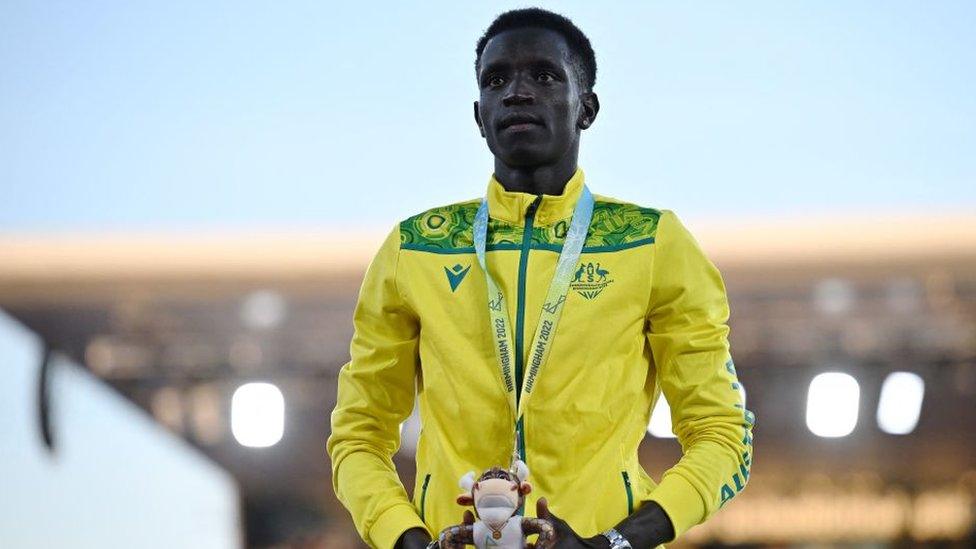 Peter Bol poses during a medal ceremony