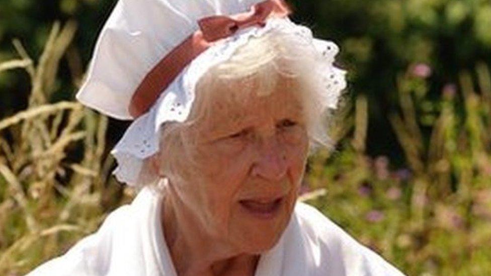 Volunteer costumed interpreter in the garden at Coleridge Cottage