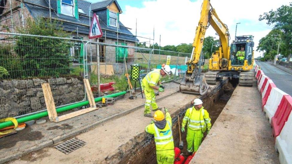 Roadbridge workers laying cable