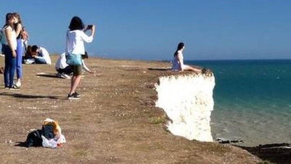 Tourist at cliff edge