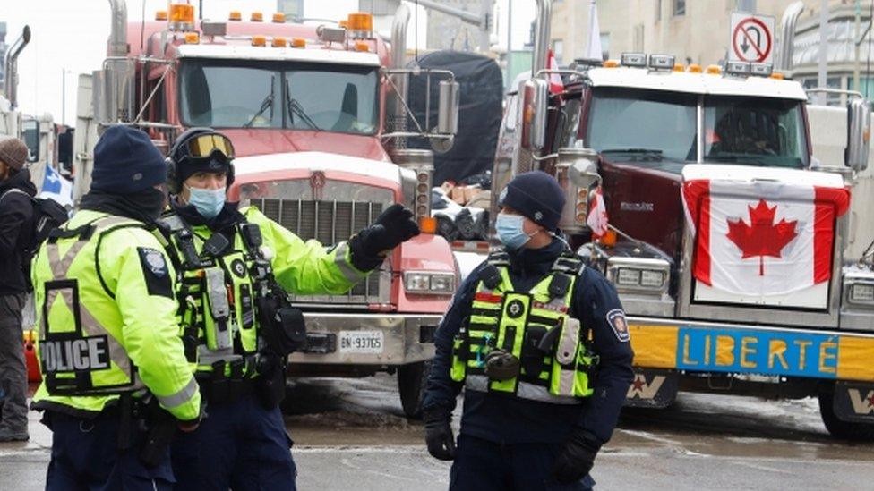 Police members patrol a downtown area