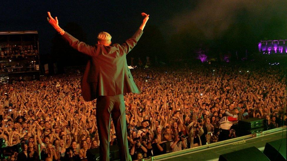 Theo Ellis, from Wolf Alice, takes to the stage at Latitude Festival 2021