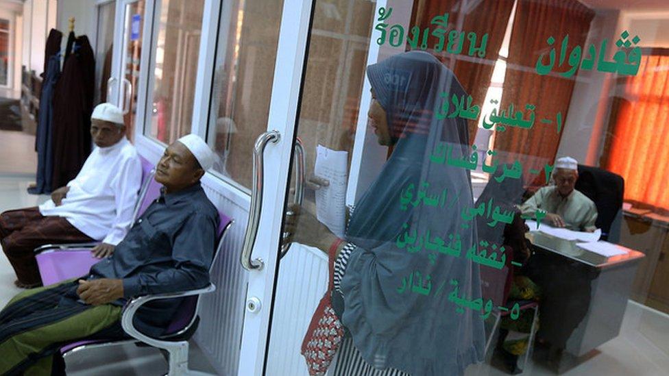 A Muslim woman walks out of the complaint room at Pattani's Islamic Council.