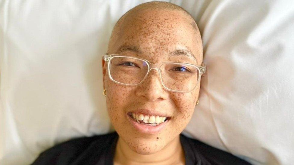 Woman in hospital bed smiling