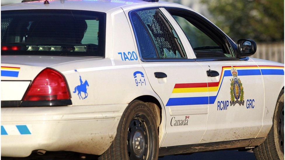 A Codiac RCMP officer drives on with her rear passenger window shattered in Moncton, New Brunswick June 4, 2014.