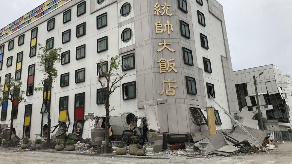 A hotel is pictured with its bottom floors crushed