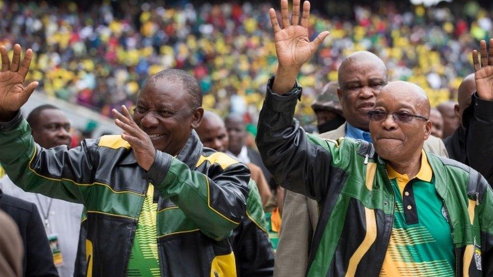 South African President Jacob Zuma (R) and Deputy President Cyril Ramaphosa wave to supporters at a rally to commemorate the 105th birthday of the ruling African National Congress