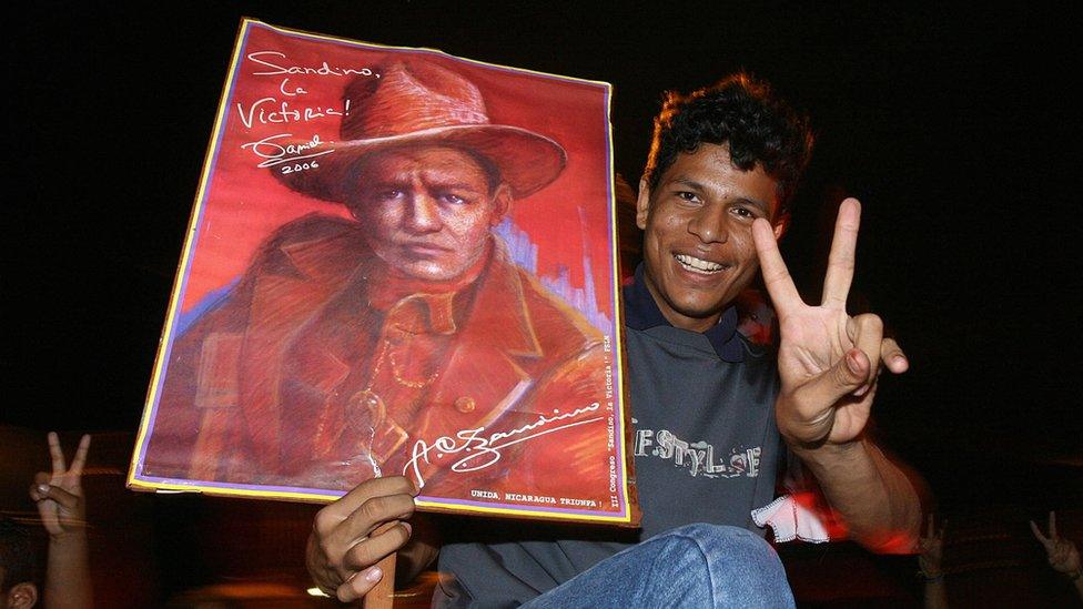 Supporters of Sandinista National Liberation Front (FSLN) candidate Daniel Ortega celebrate in the streets of Managua with a portrait of Augusto Cesar Sandino in 2006