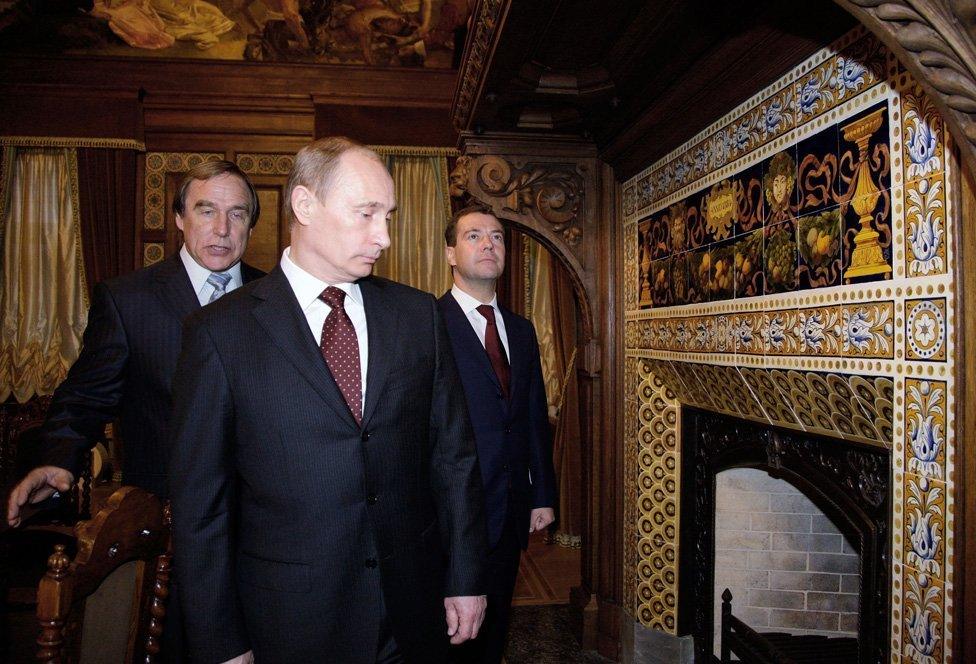 2009 picture Dmitry Medvedev (R) and PM Vladimir Putin (front), St Petersburg House of Music's artistic director Sergei Roldugin