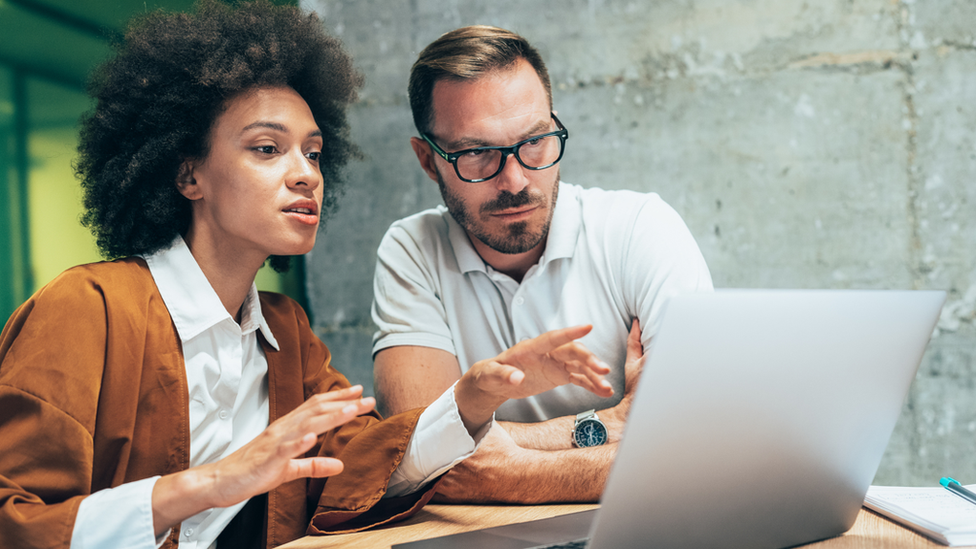 Woman and man working at computer