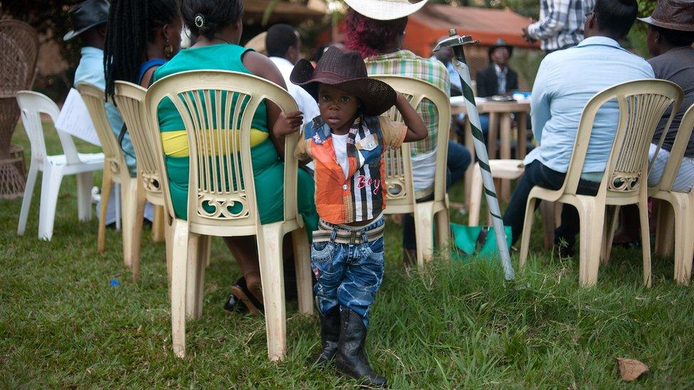 Alvin Kivumbi, aged three, wears a cowboy outfit in Kampala