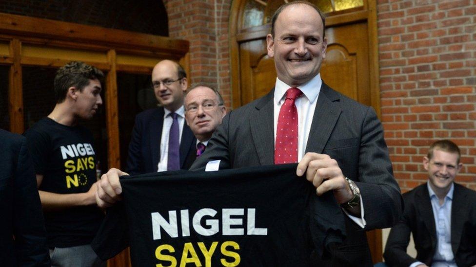 Douglas Carswell holds up a "Nigel says No" t-shirt at UKIP conference