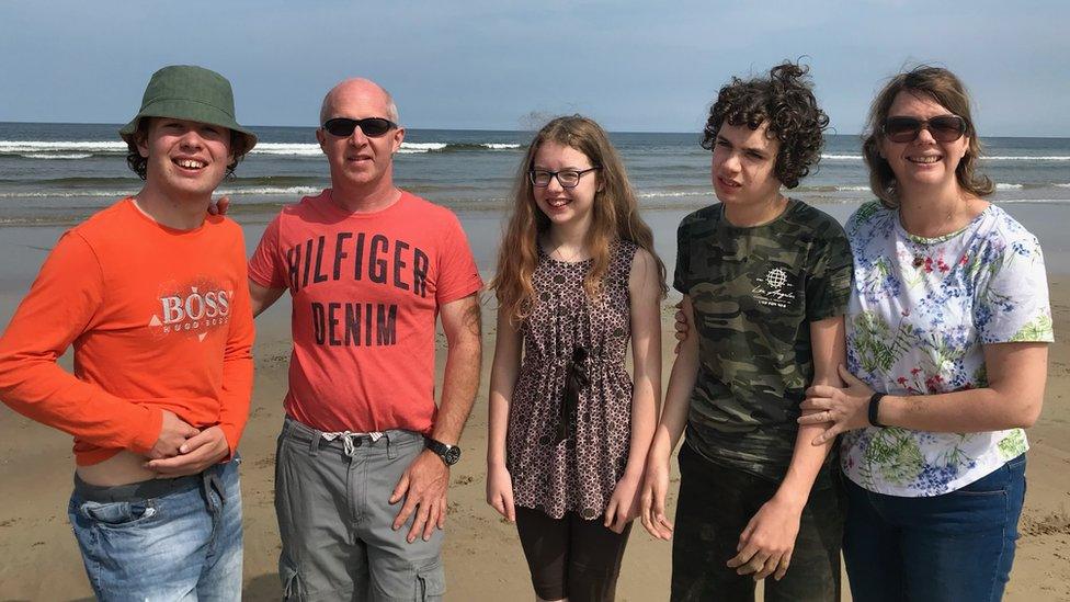 A photo of David, Simon, Emma, Mark and Jennifer Bullock at the beach