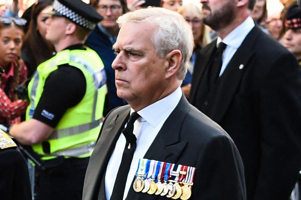 Prince Andrew walking behind hearse