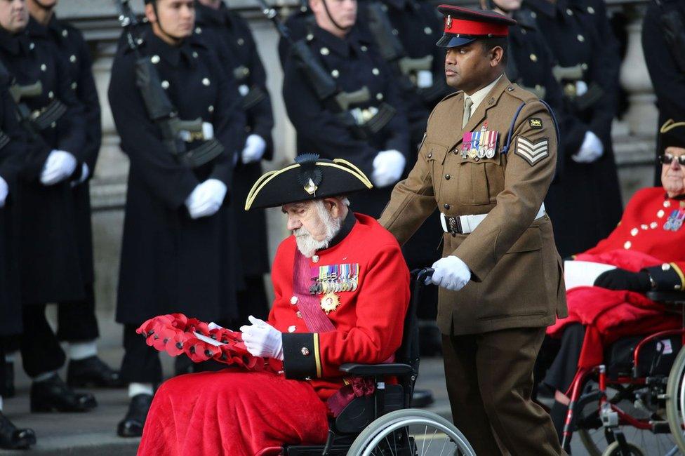 Johnson Beharry pushes Bill Speakman, both VC during the annual Remembrance Sunday service at the Cenotaph in Whitehall